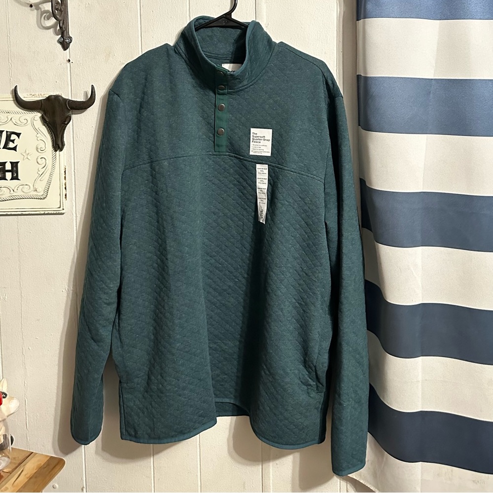 A green quarter button sweater